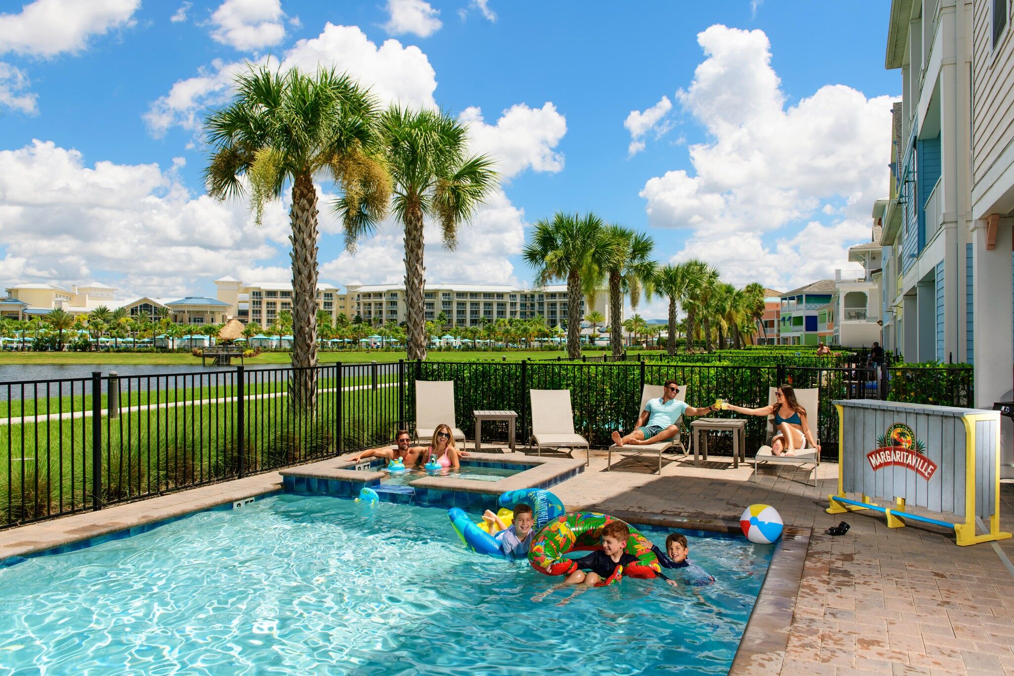 Group enjoying the private outdoor pool of their Margaritaville Cottage