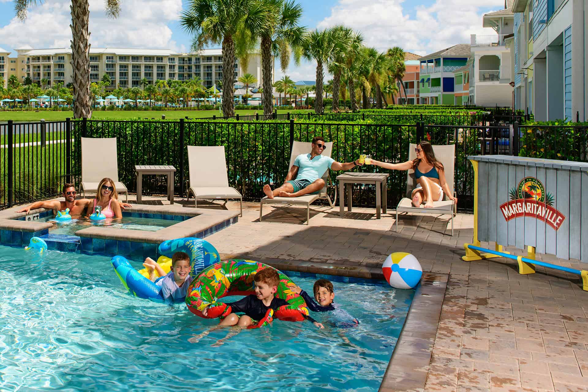 Family with kids playing in a private pool at Margaritaville Cottages Orlando