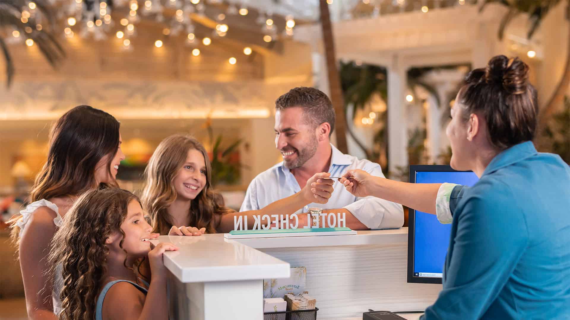 Concierge Services 1 A concierge agent greets a family at the Margaritaville Resort Orlando lobby.